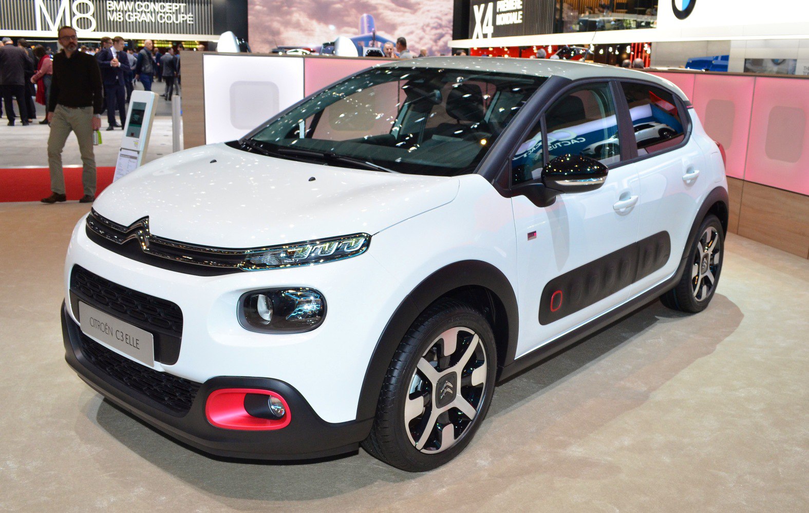 White compact hatchback with distinctive front lights and Airbump side panels