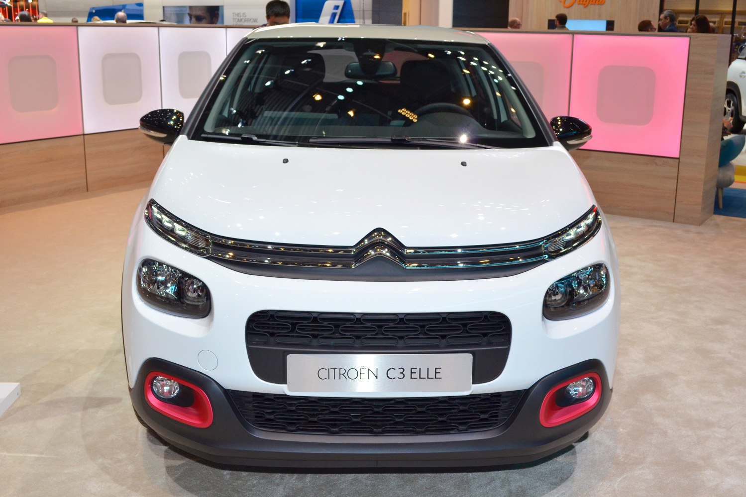 Front view with split headlights, black grille, and red-trimmed fog lights