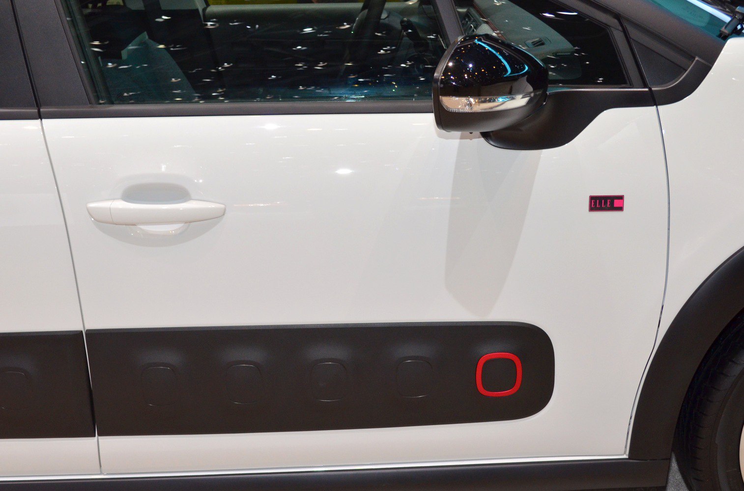 White car door with black Airbump panel and red accent detail