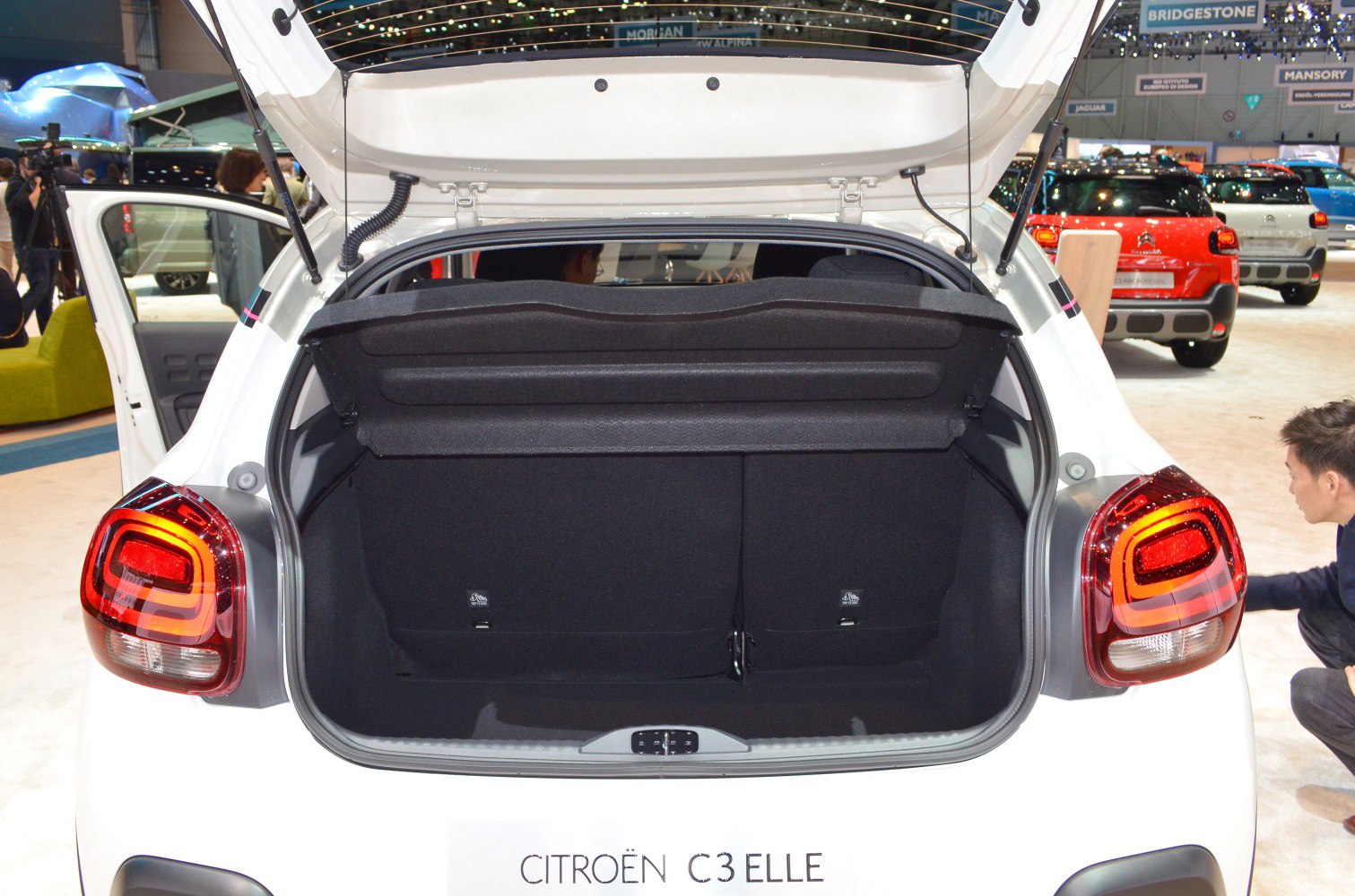 Open hatchback trunk space with rear lights of compact vehicle