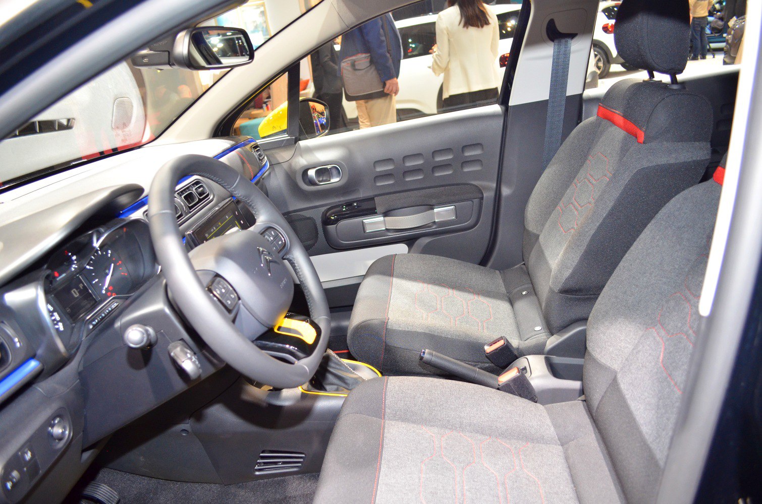 Dashboard and fabric seats with hex pattern and red accents