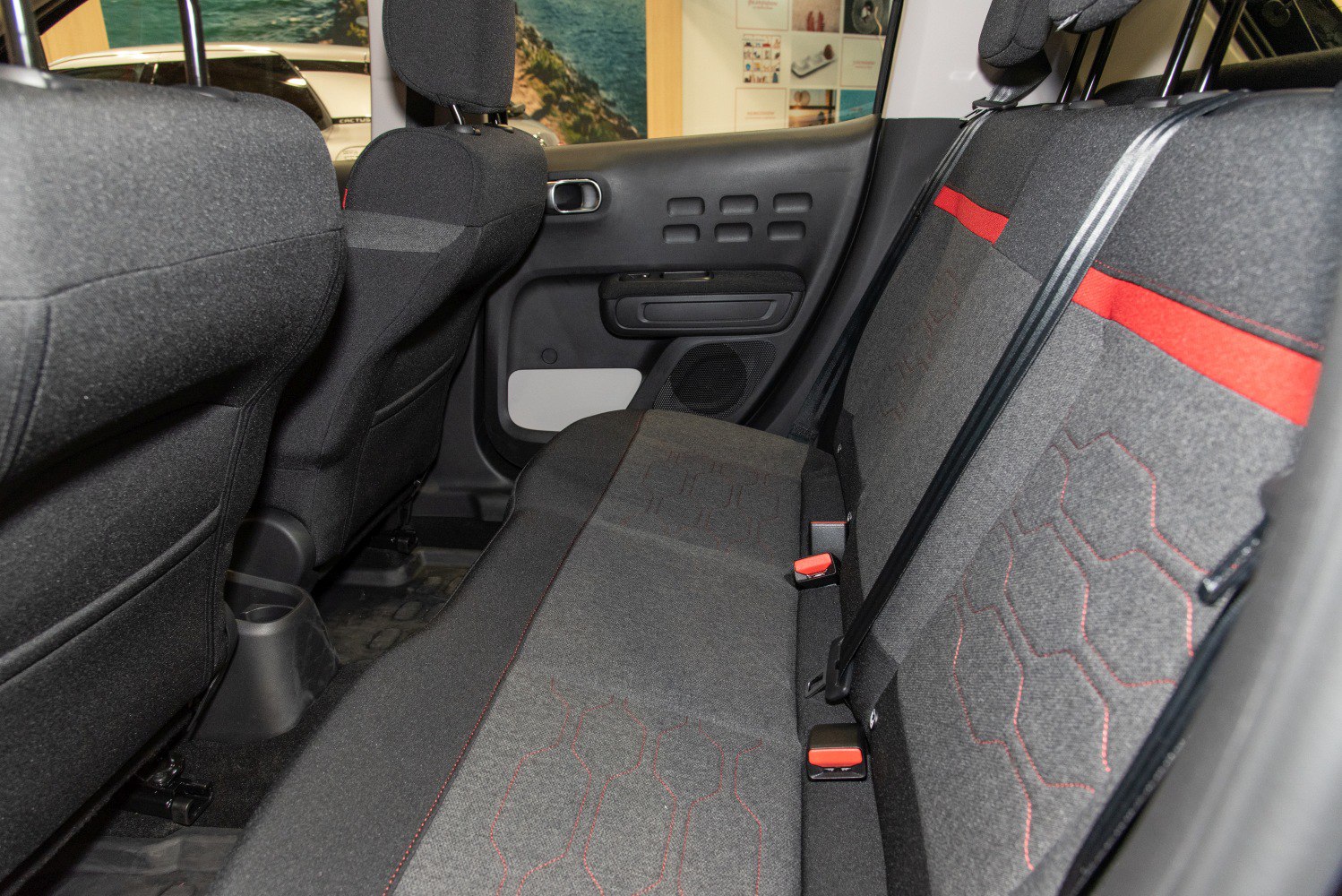 Rear seat fabric interior with red stitching and an accent stripe