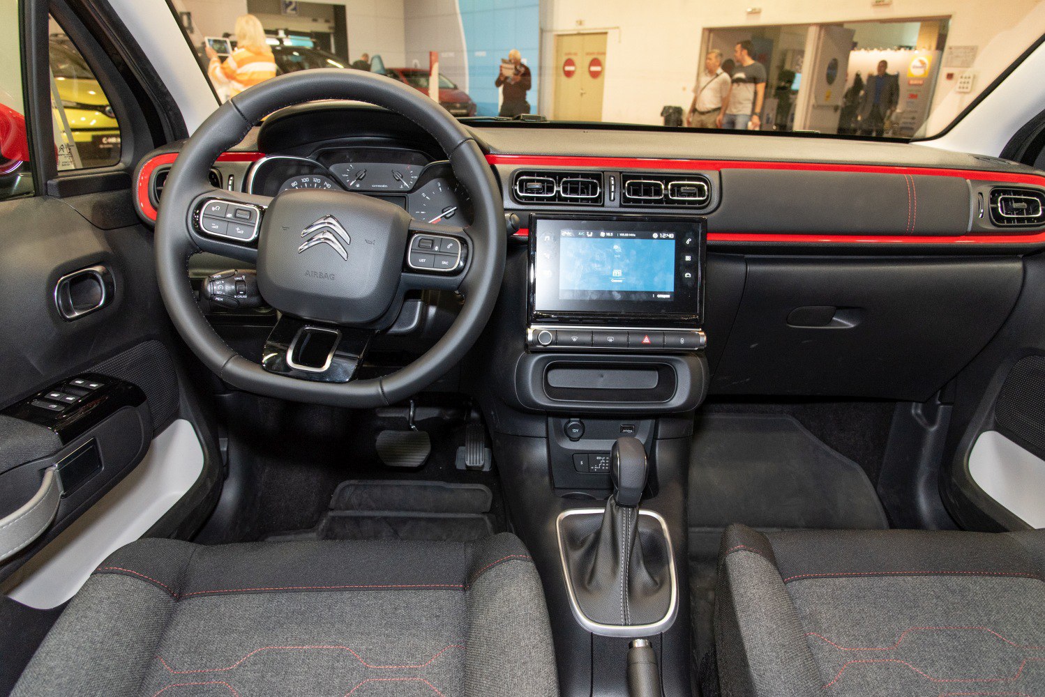 Digital infotainment screen and multifunction steering wheel in car interior