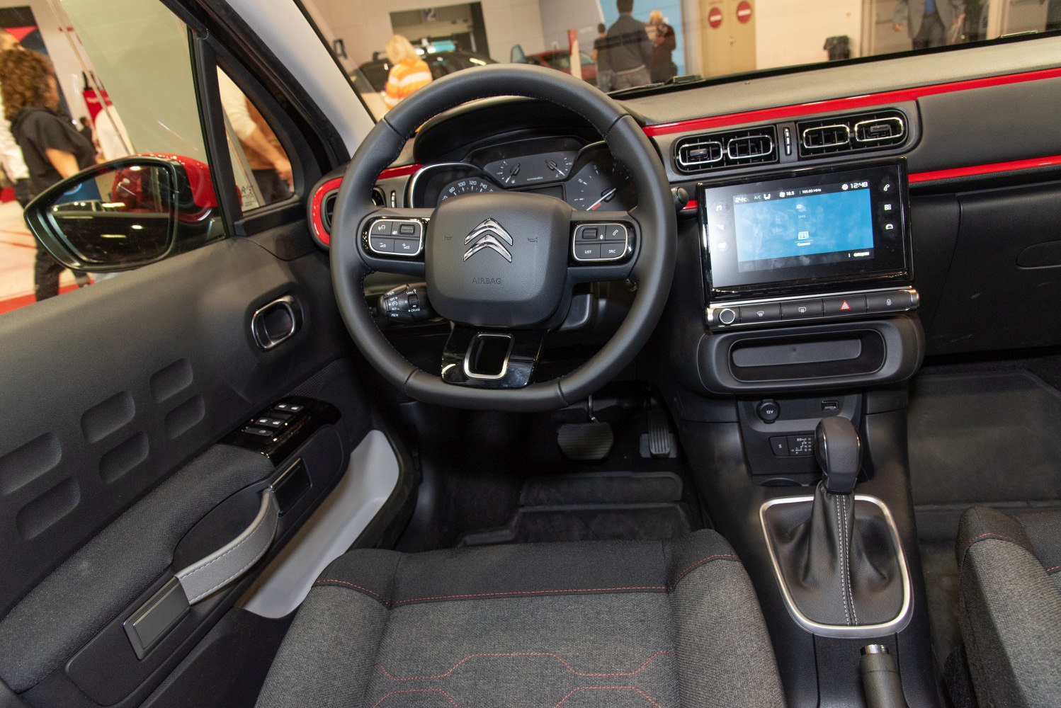 Dashboard, steering wheel with control buttons, infotainment screen