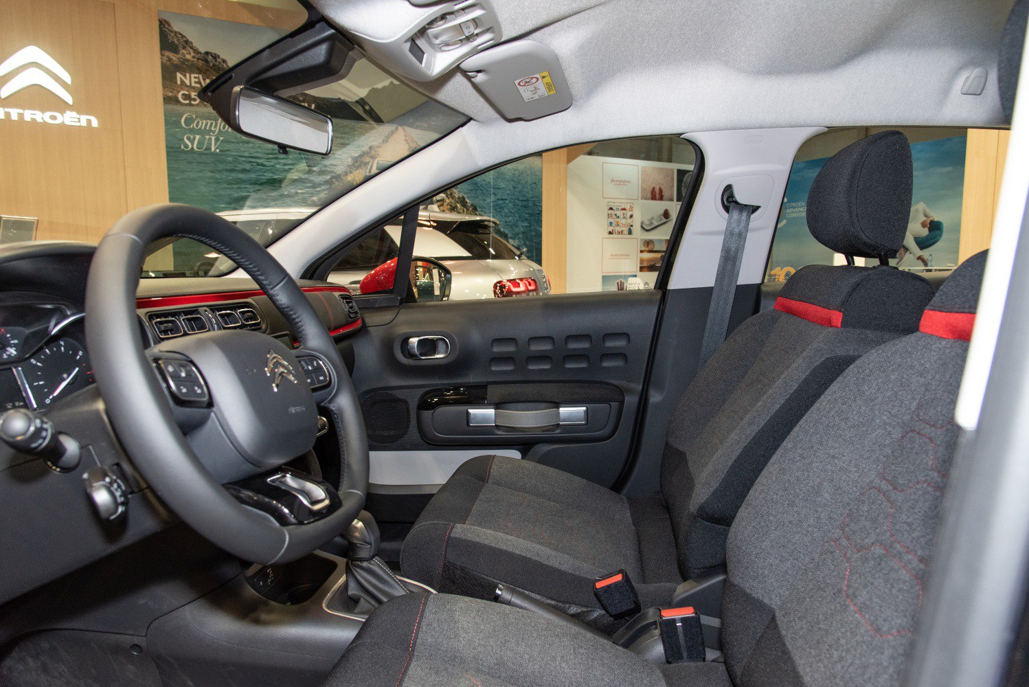 Front interior cabin seats, dashboard, and door panel with steering wheel