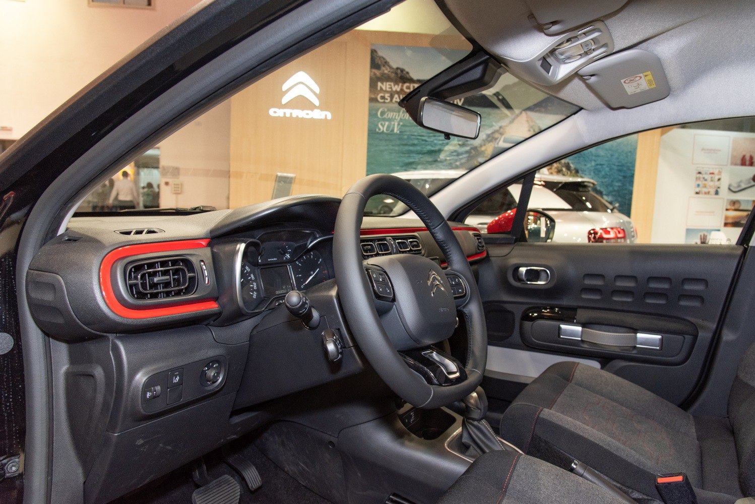 Dashboard with central air vents and multifunction steering wheel
