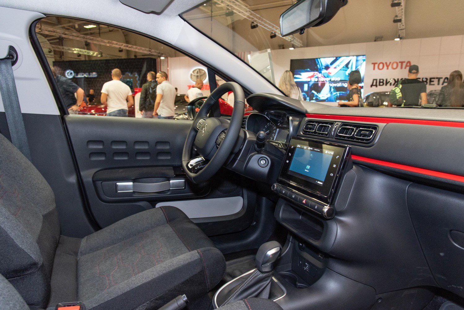 Dashboard with touchscreen and ergonomic steering wheel in compact vehicle interior
