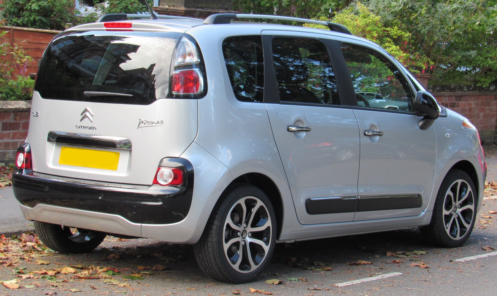 Rear side view showing tail lights and alloy wheels