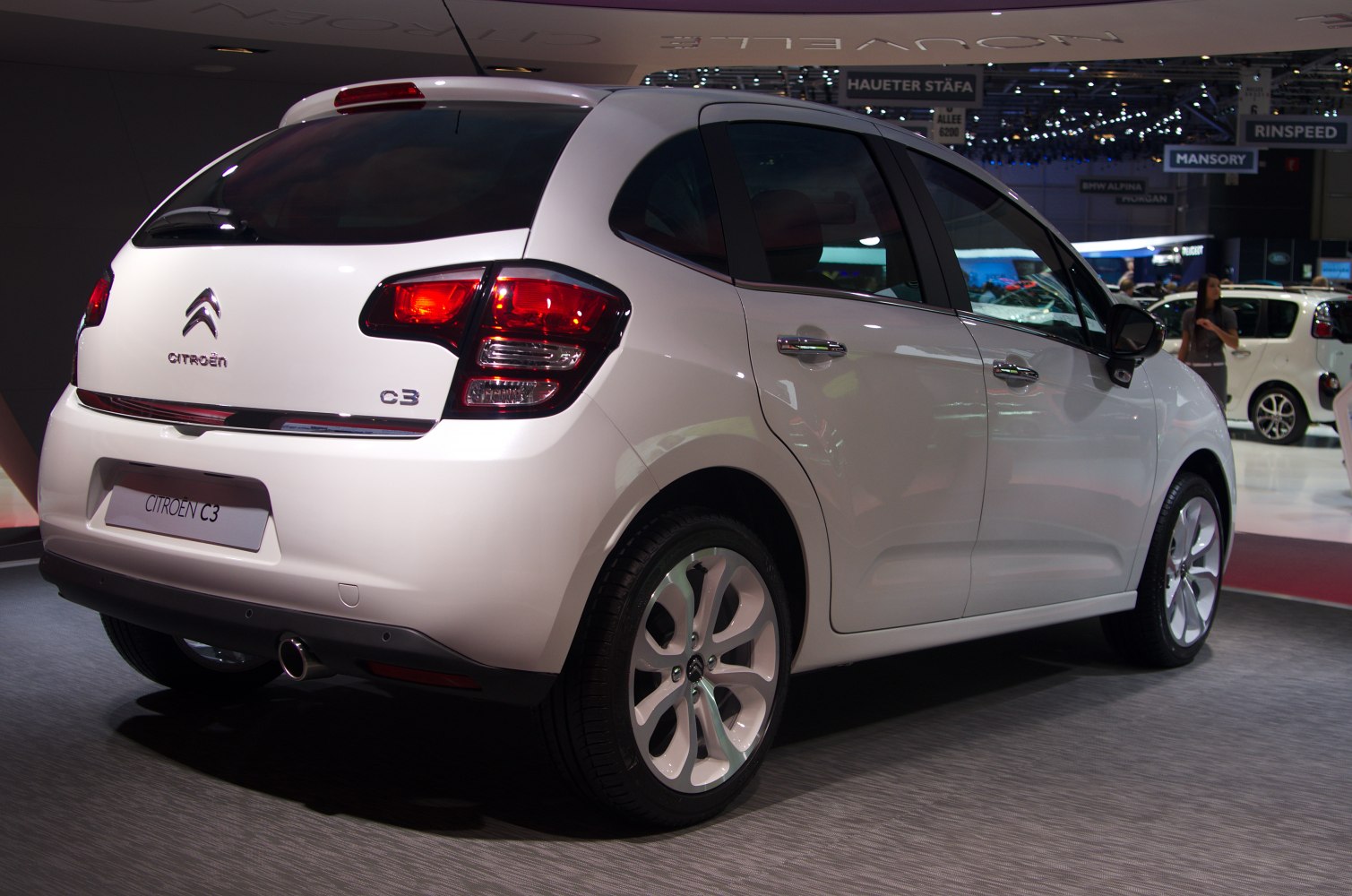 White compact hatchback rear with distinctive taillights and alloy wheels