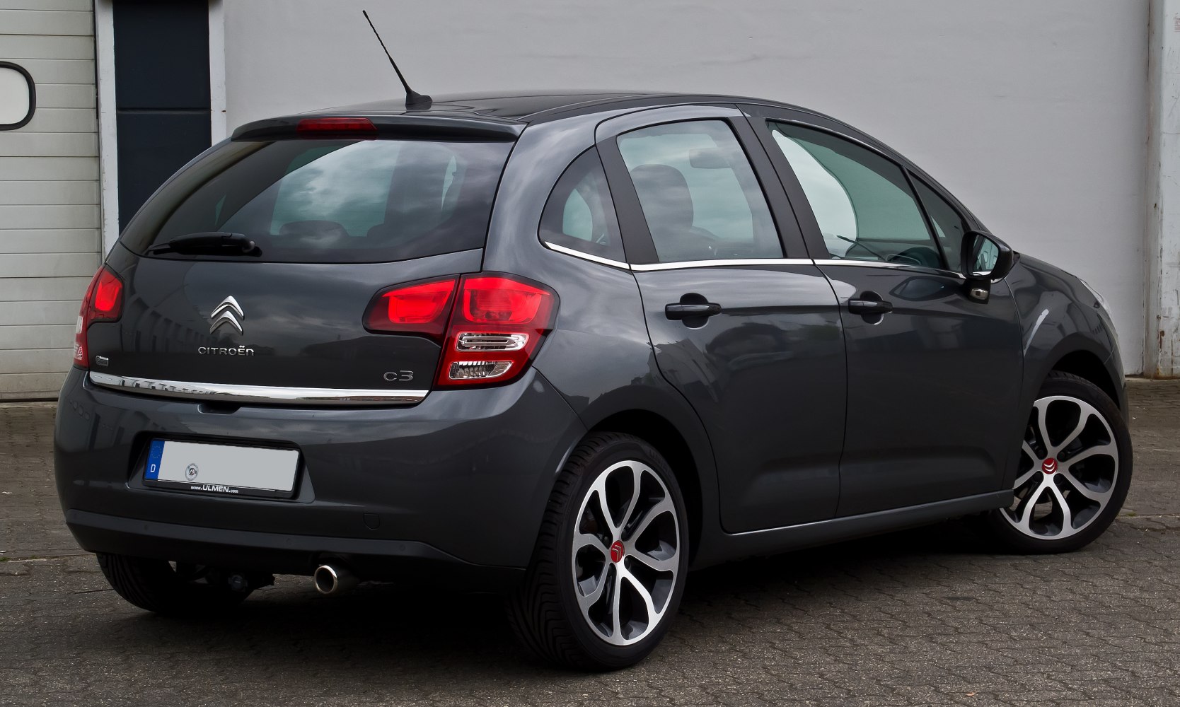 Rear side view of a compact hatchback with vertical tail lights and dual-tone alloy wheels