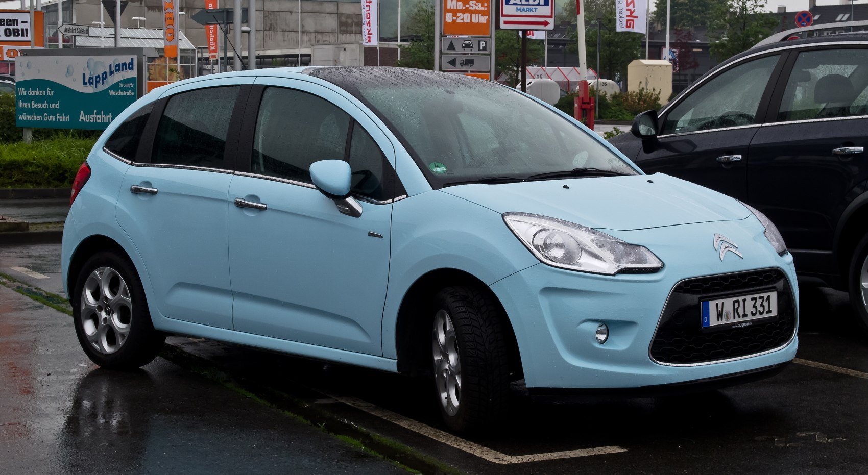 Compact light blue hatchback with unique front grille and headlights.