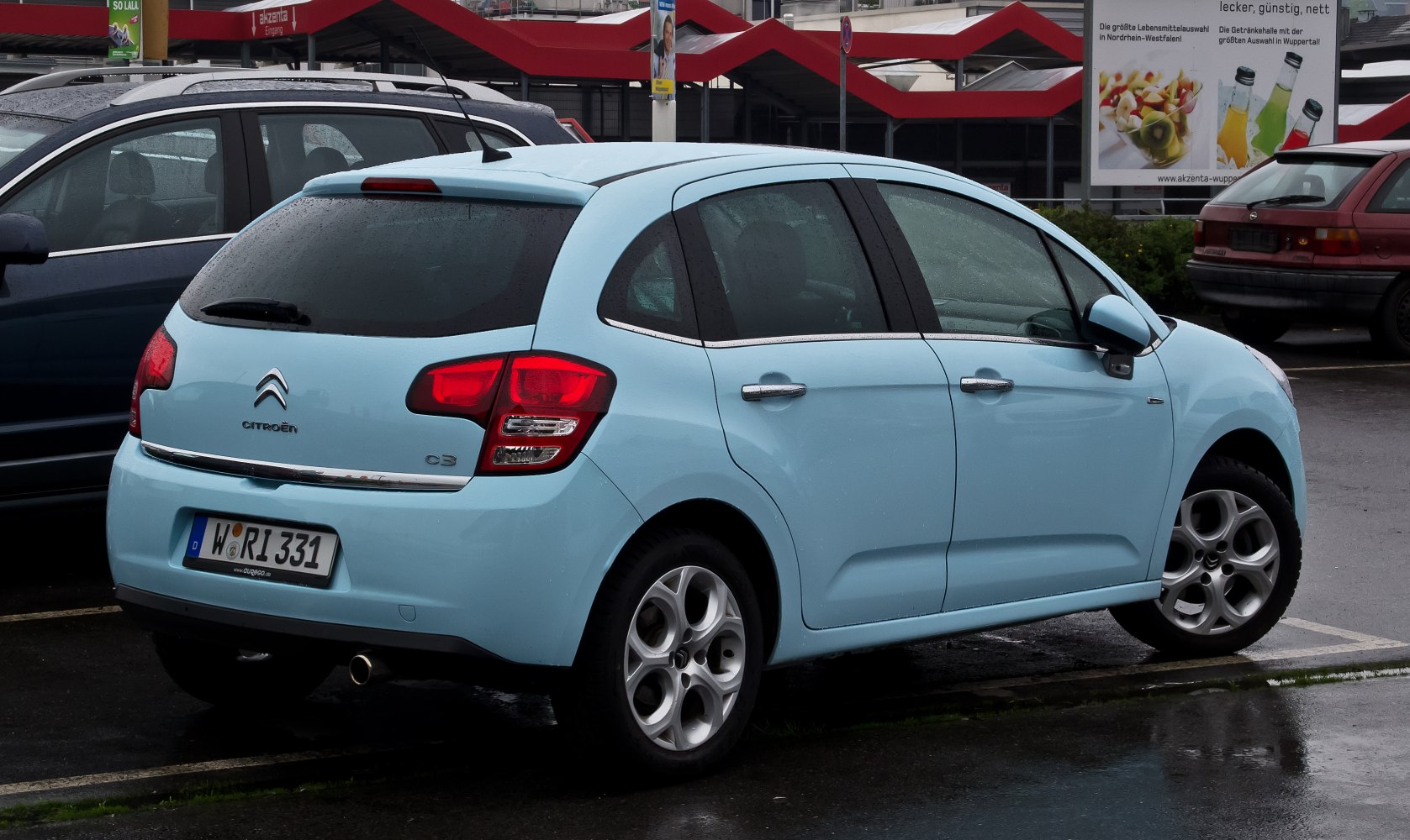 Rear and side view of hatchback with distinctive taillights and alloy wheels