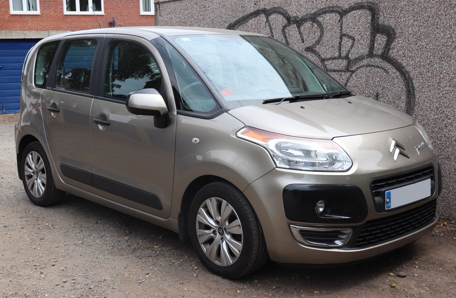 Compact MPV front-side view with distinctive headlight and black bumper