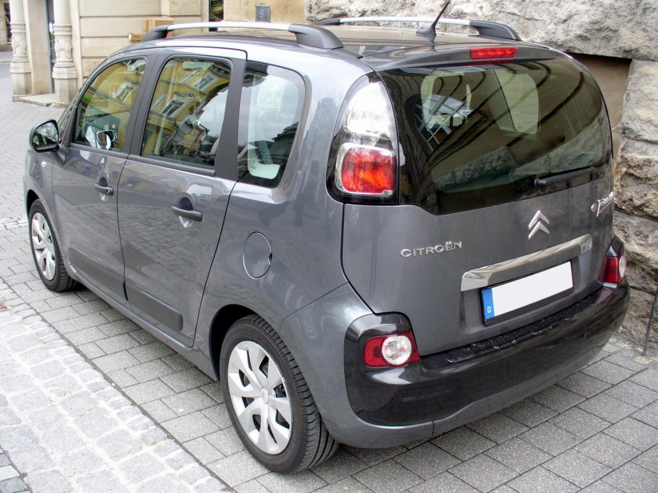 Rear and side view of compact MPV with roof rails and distinct rear lights