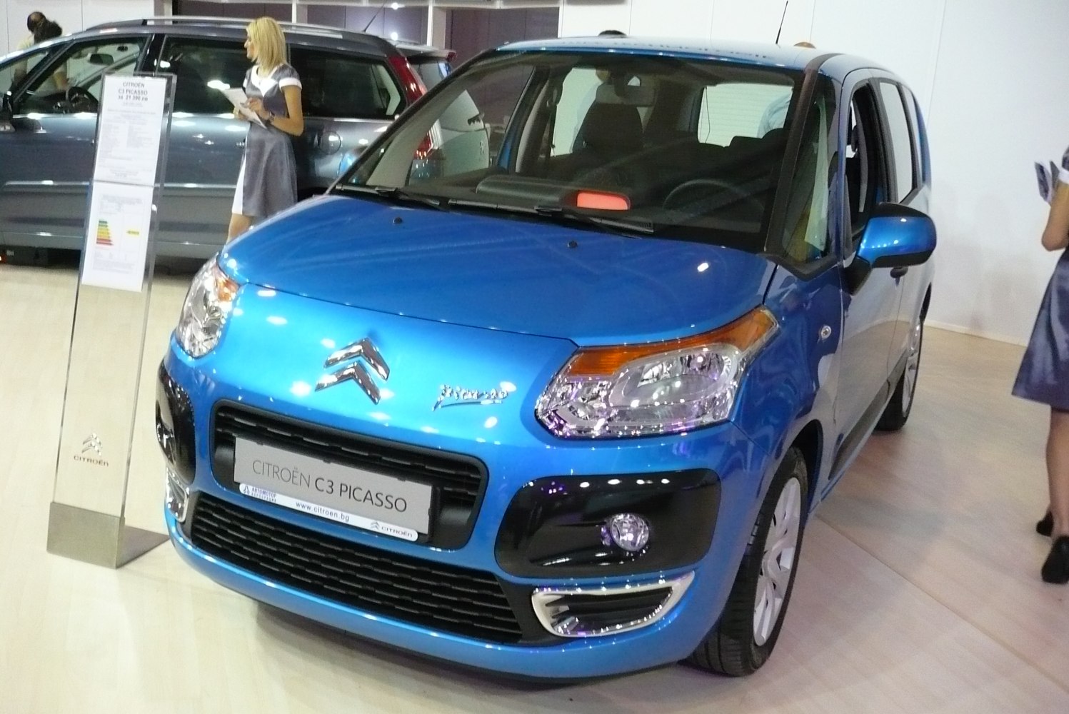 Front close-up of compact vehicle with distinctive headlights and grille