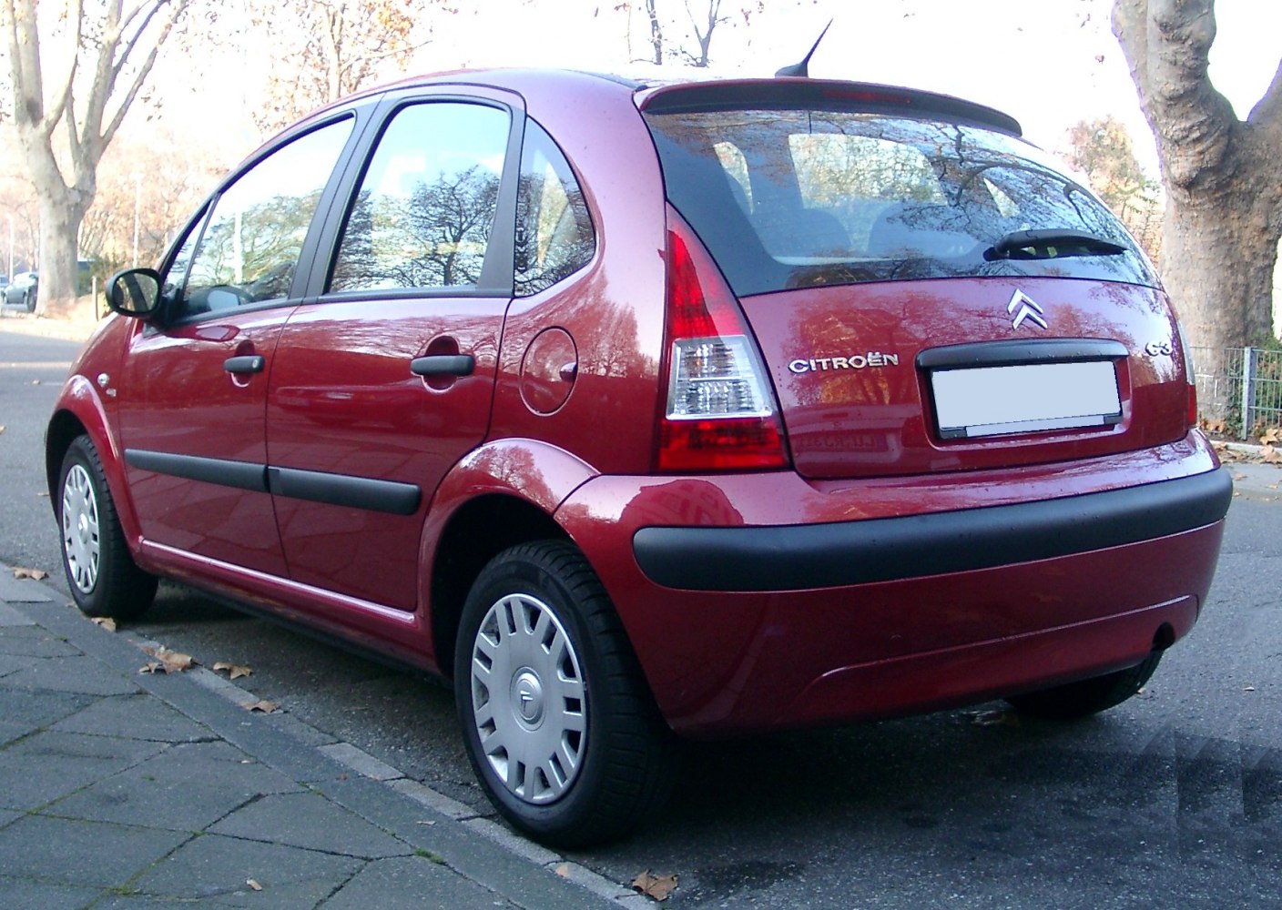 Rear side view of a compact hatchback with distinct tail lights and curved body.