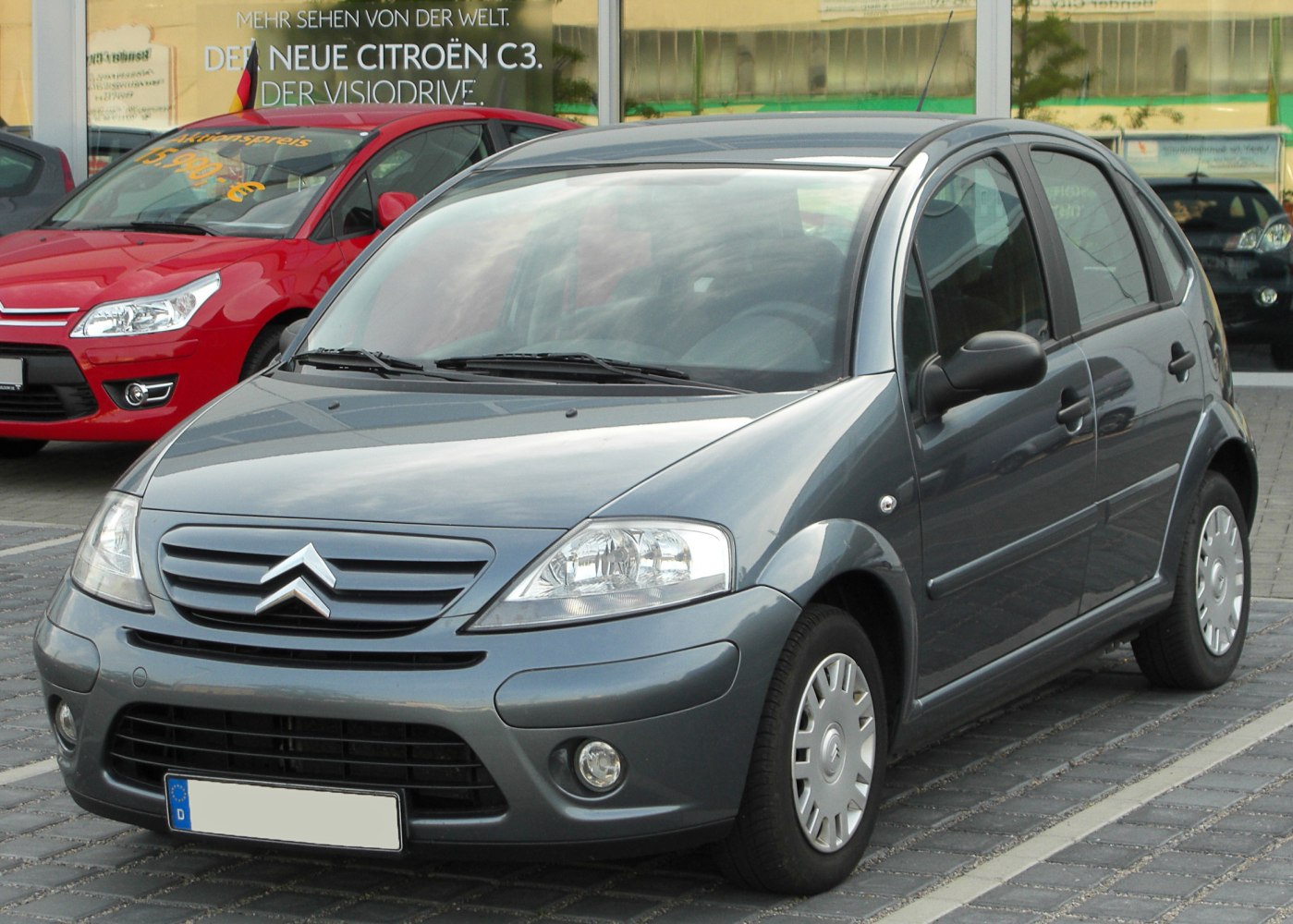 Compact hatchback front view with distinctive grille and fog lights
