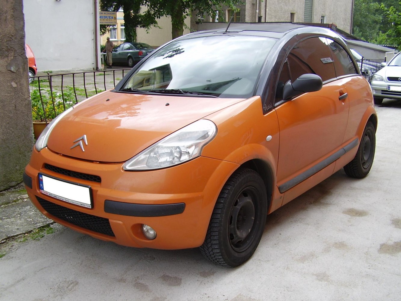 Compact hatchback with black roof and distinct headlights