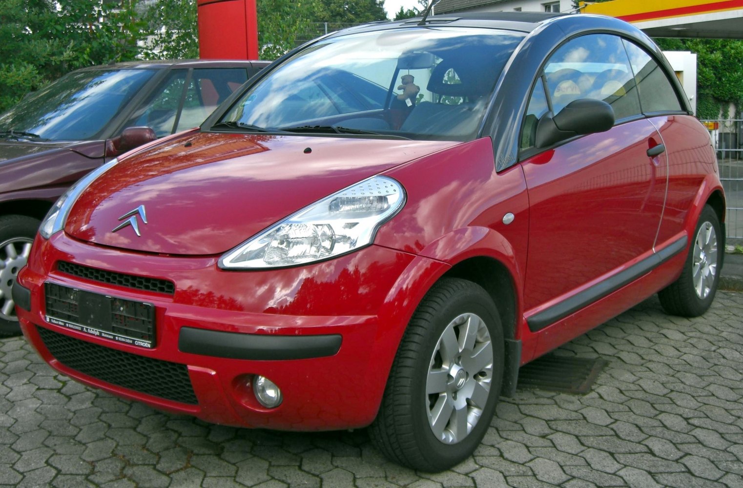 Compact hatchback convertible with rounded headlights and unique roofline