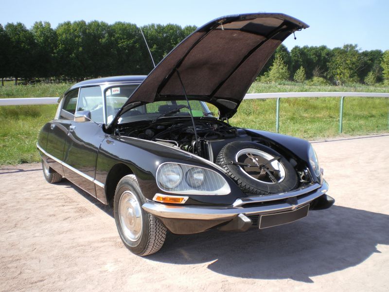 Open hood with visible engine bay and front-mounted spare tire