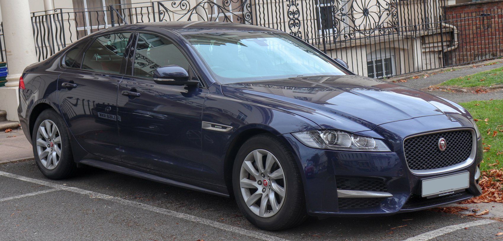 Front and side profile of a sleek sedan with distinctive grille and headlamps