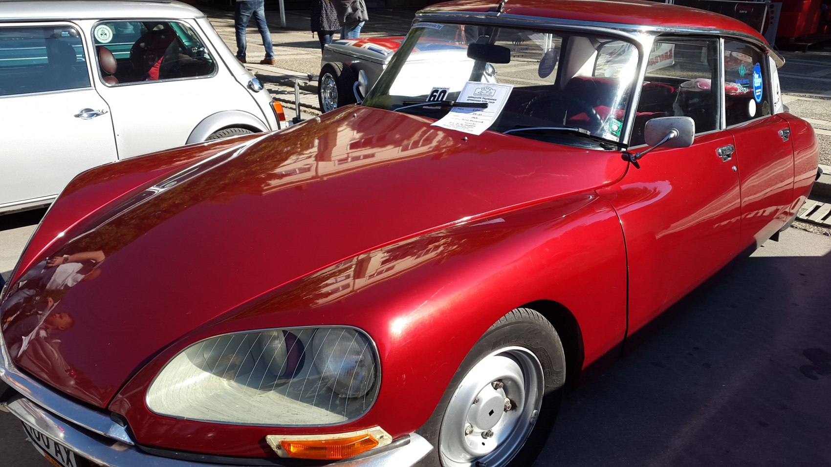 Vintage vehicle with rounded headlights and sleek shiny hood