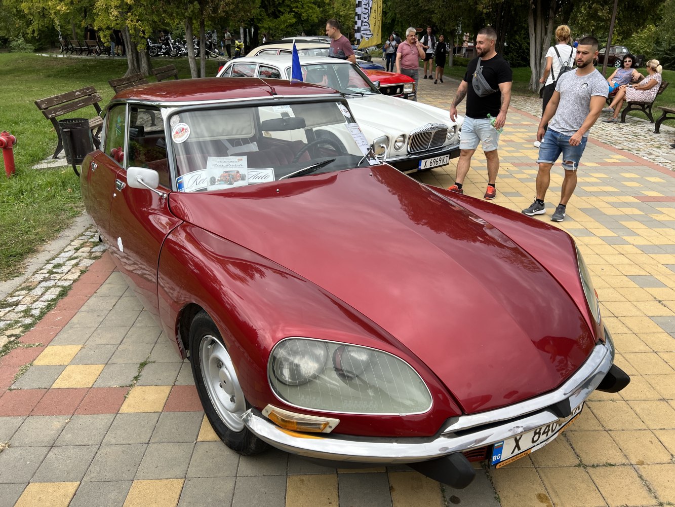 Close-up of a vintage car's hood and distinctive front headlights.