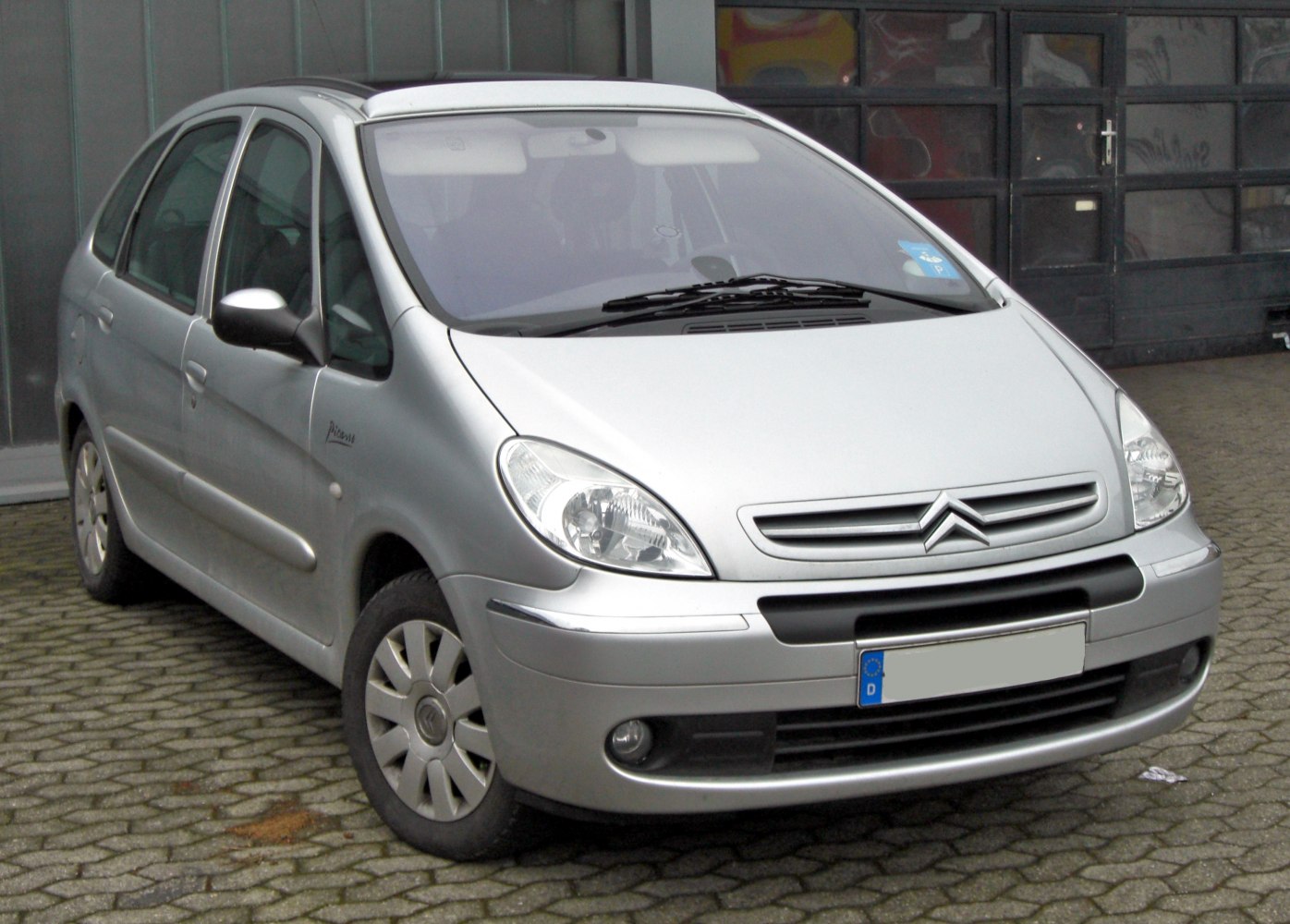 Silver compact minivan with rounded headlights and black grille strip