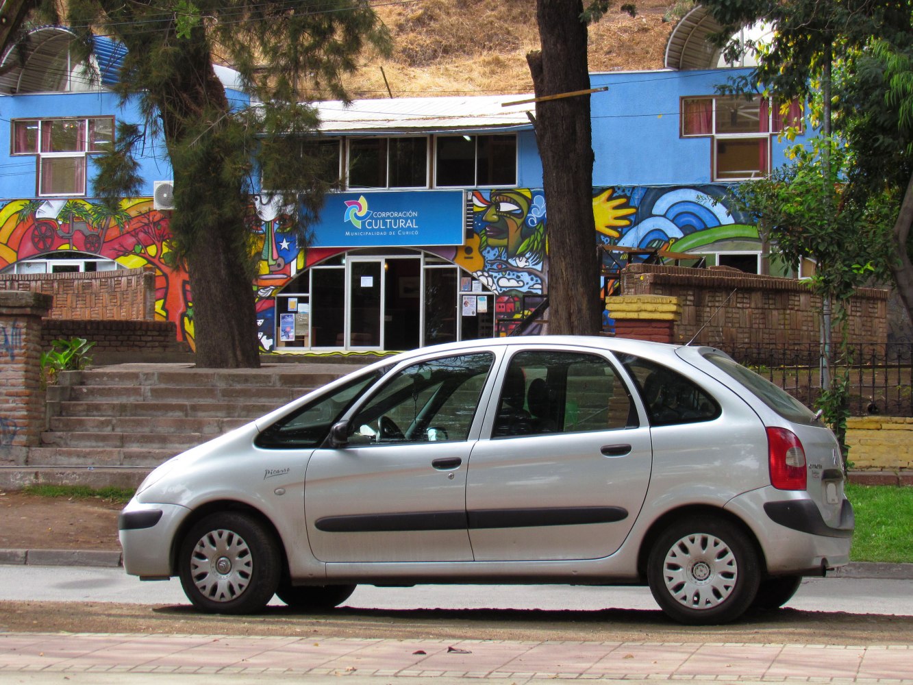 Silver five-door hatchback with rounded compact design and black door molding