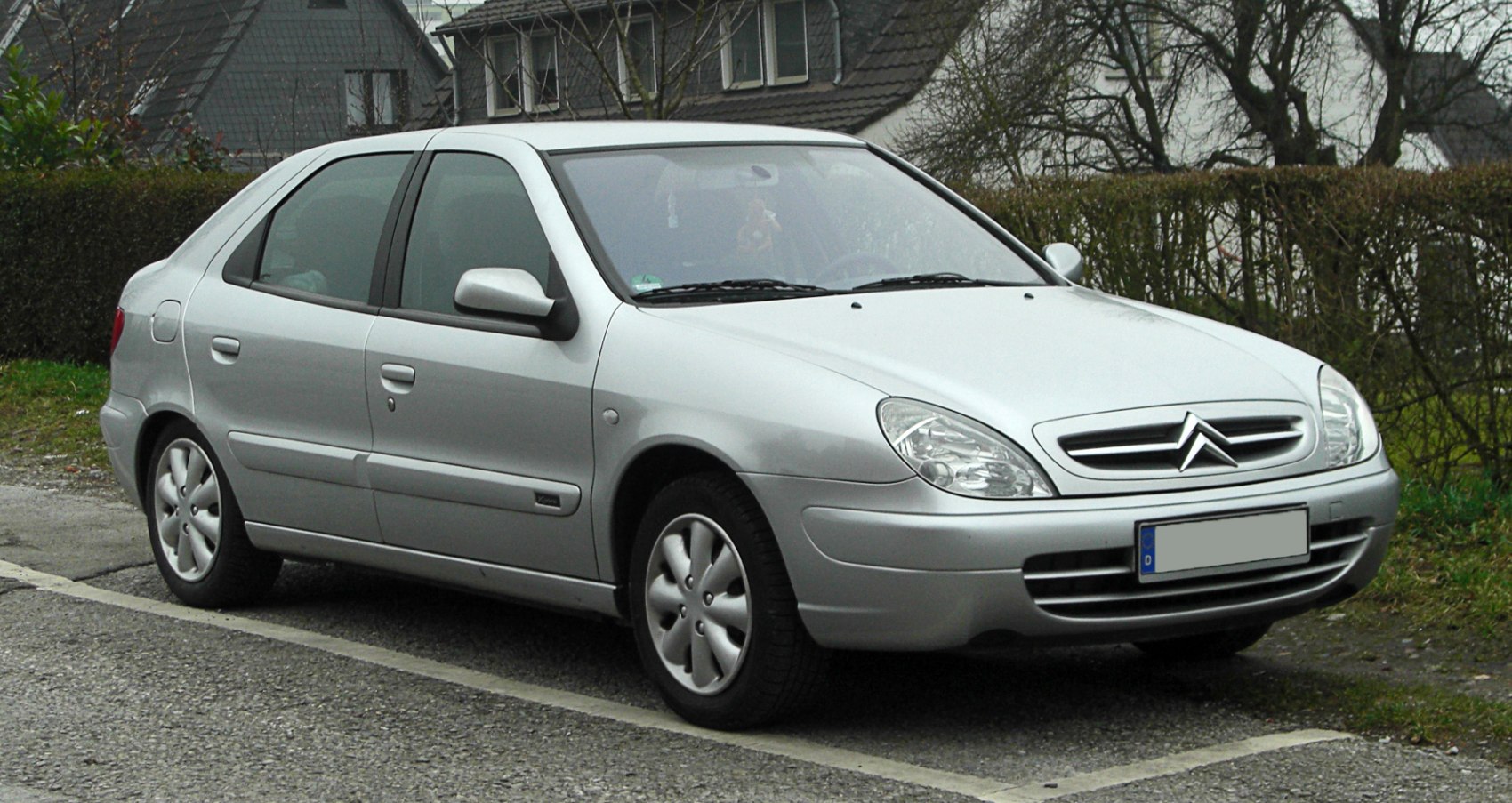 Silver compact sedan with aerodynamic headlights and distinctive grille