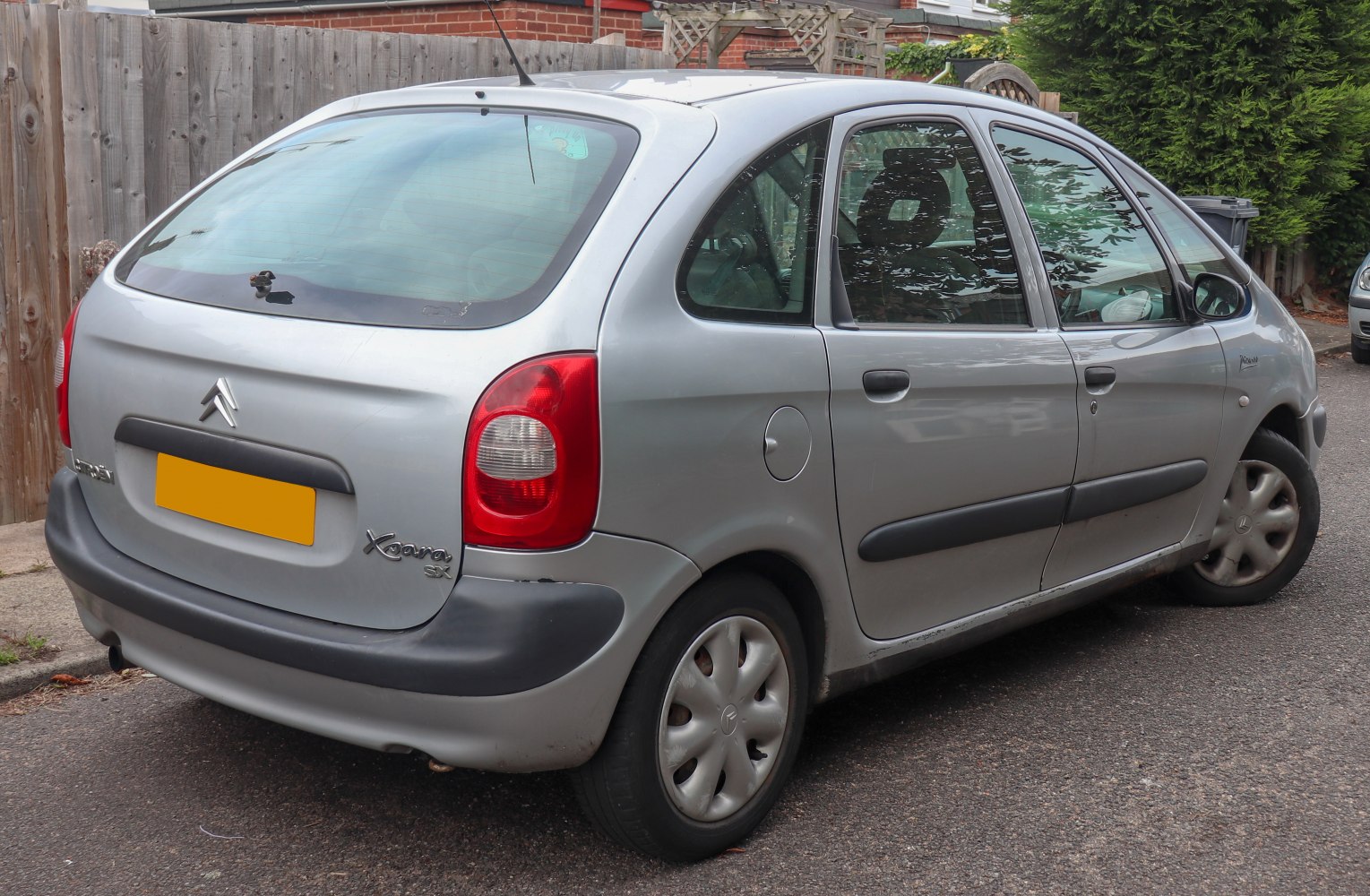 Rear and side view of a silver hatchback with rounded taillights and black trim