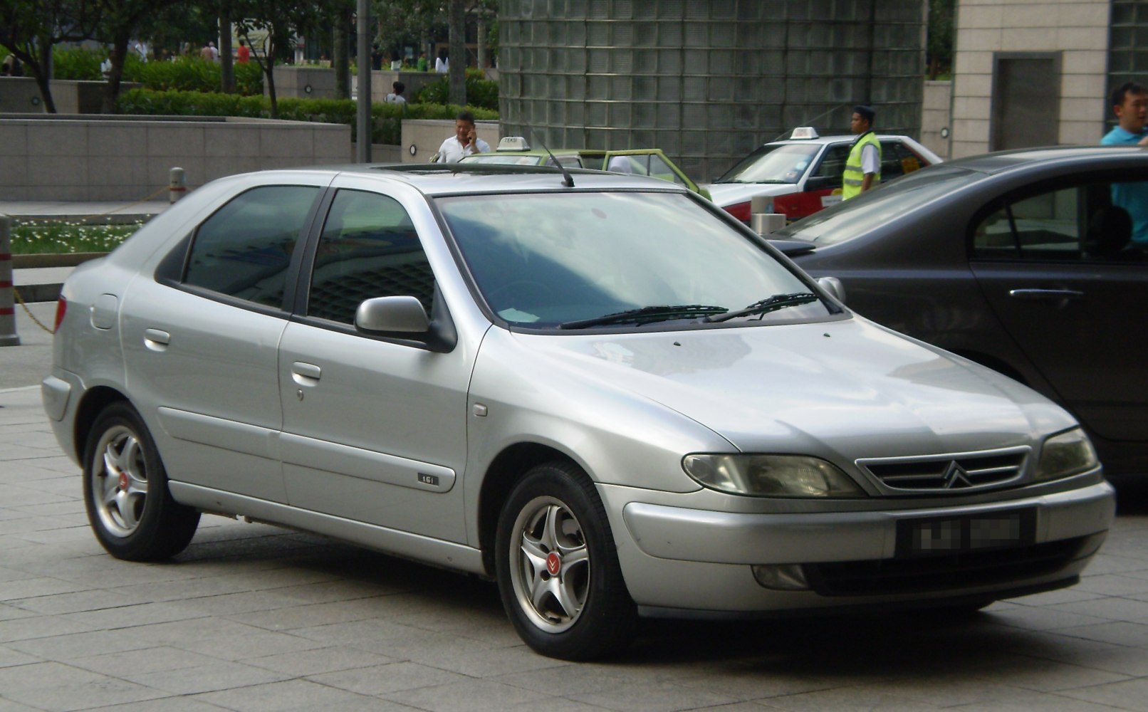 Silver mid-1990s hatchback with alloy wheels and tinted windows
