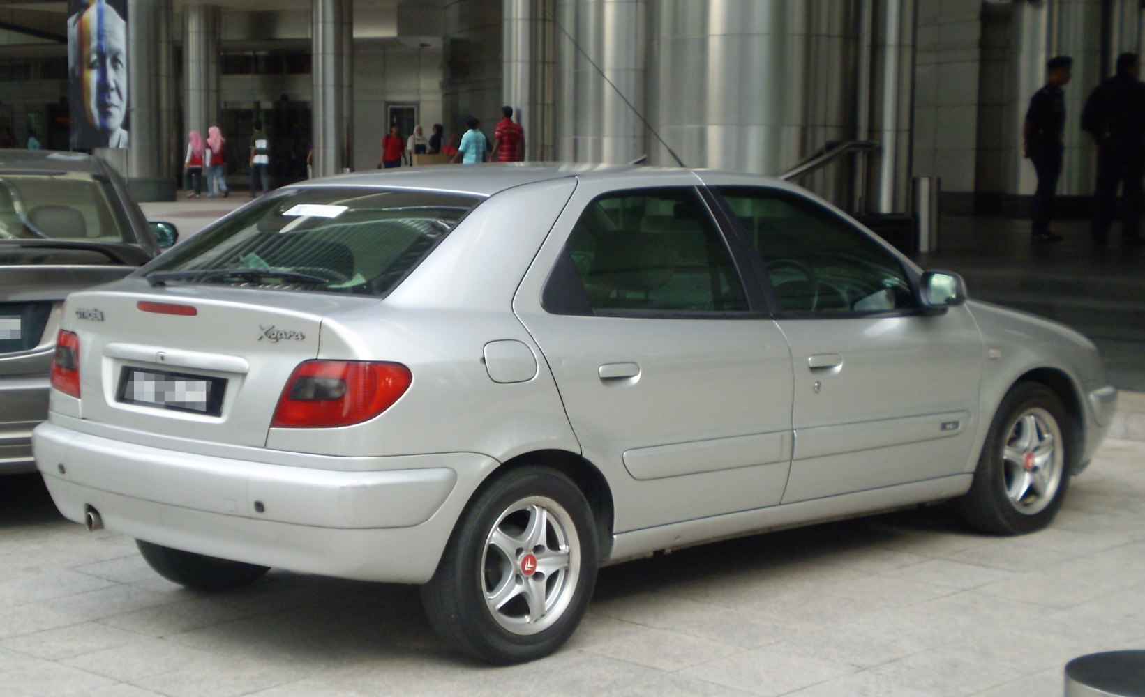 Silver hatchback sedan rear view with alloy wheels