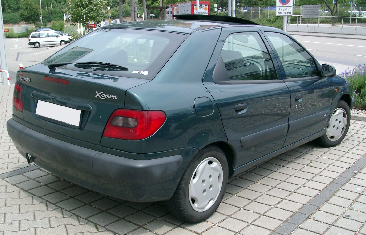 Rear and side view of a compact hatchback with rear wiper and steel wheel hubcaps