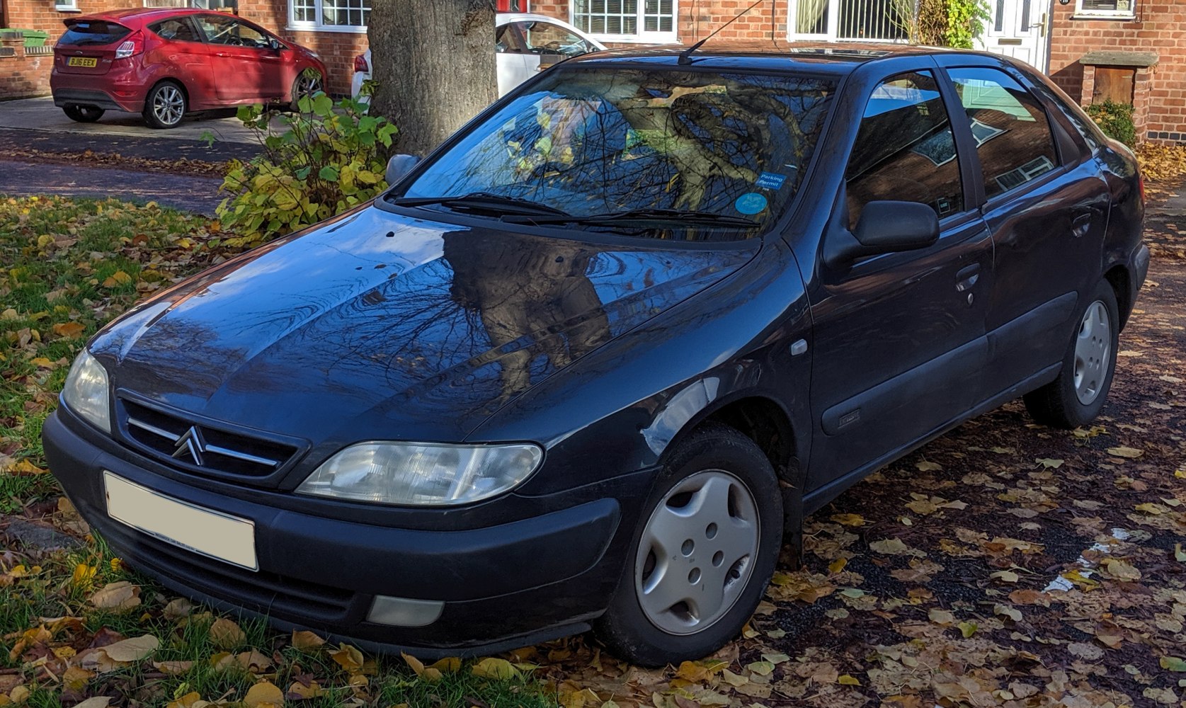 Front and side exterior of a 1997 compact sedan with clear headlights and smooth body lines