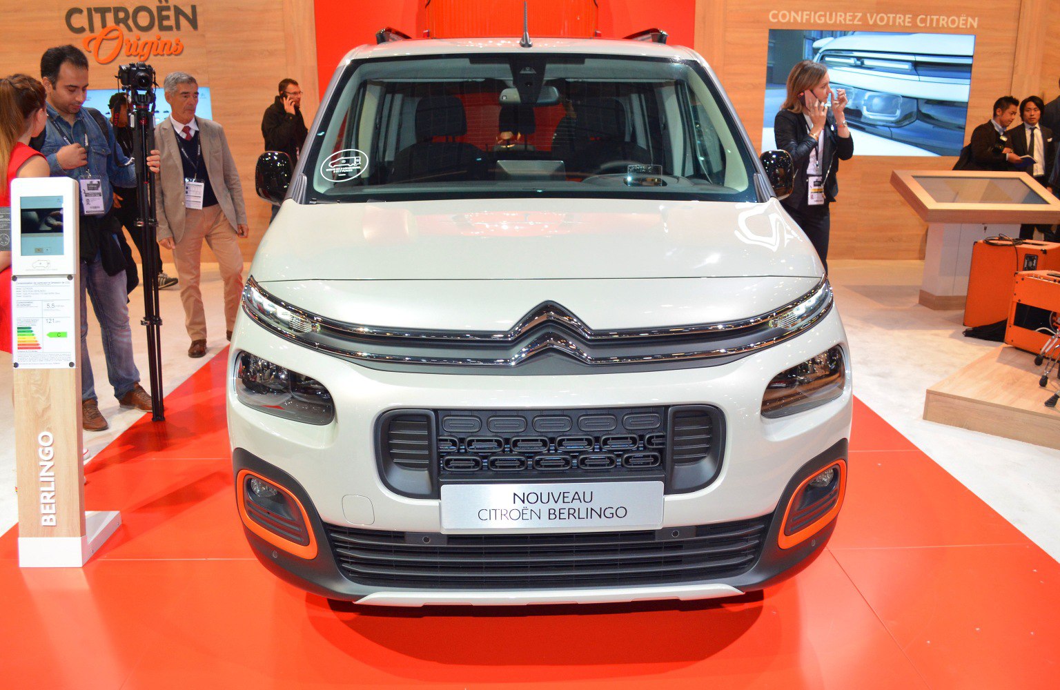 Front view featuring distinctive grille and split headlights on compact van.