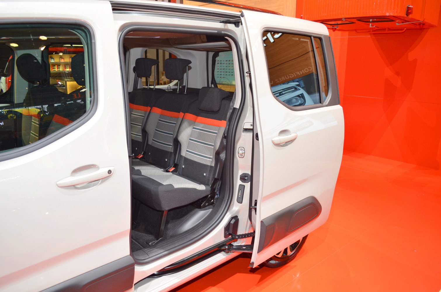 Sliding door open showing multi-seat interior with headrests