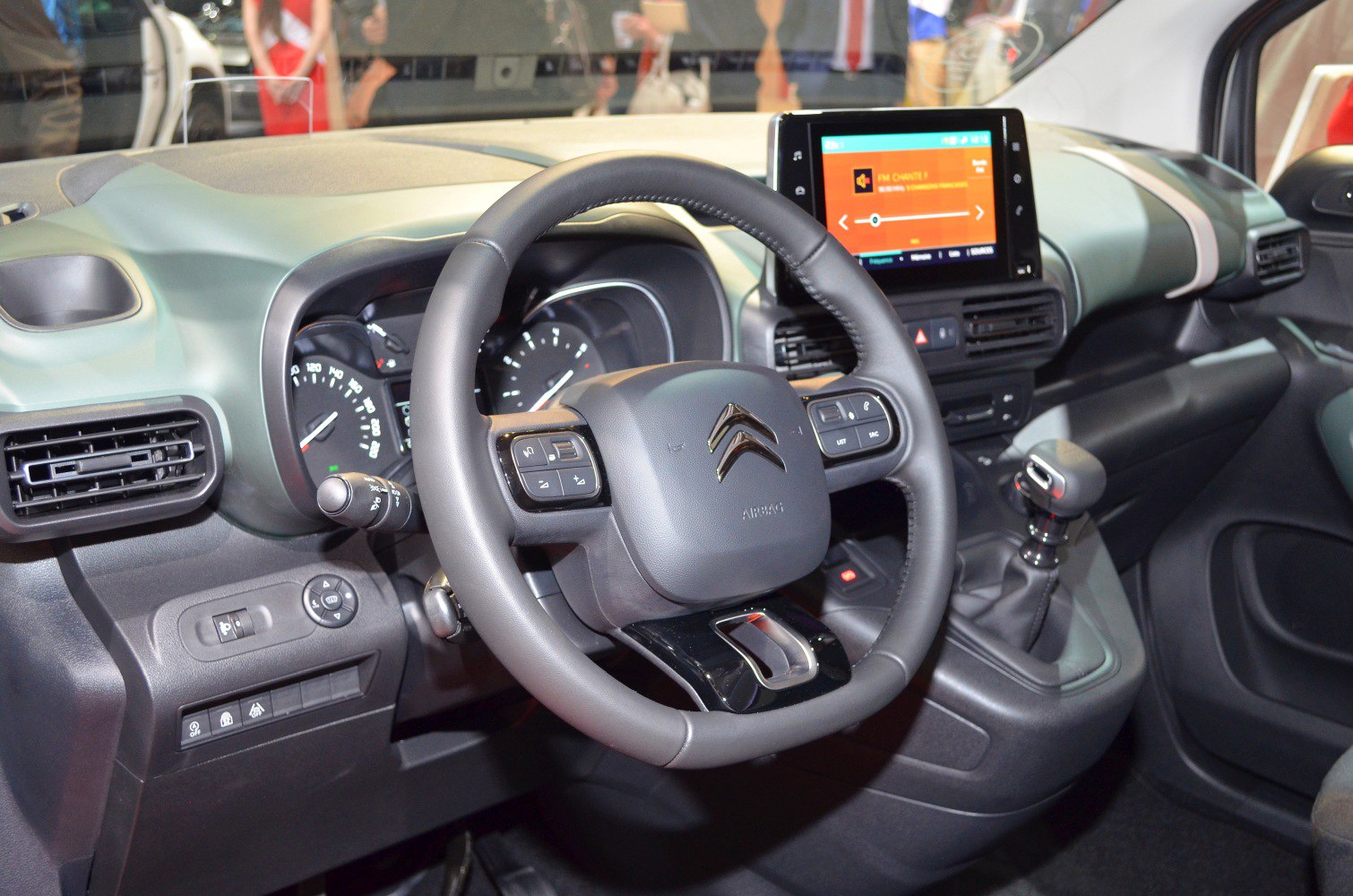 Steering wheel and touchscreen infotainment system inside vehicle cabin