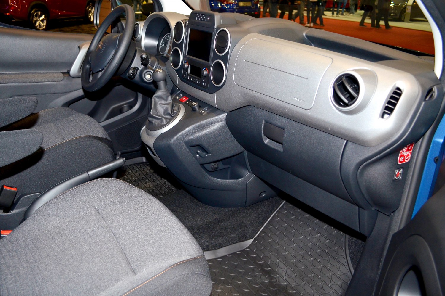 Dashboard with circular air vents and manual gearshift, cloth seats