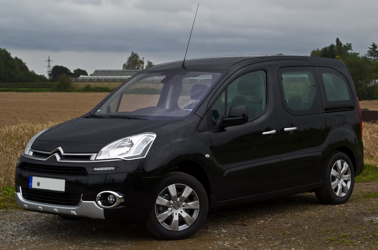 Front three-quarter exterior of compact MPV with black paint and rounded design