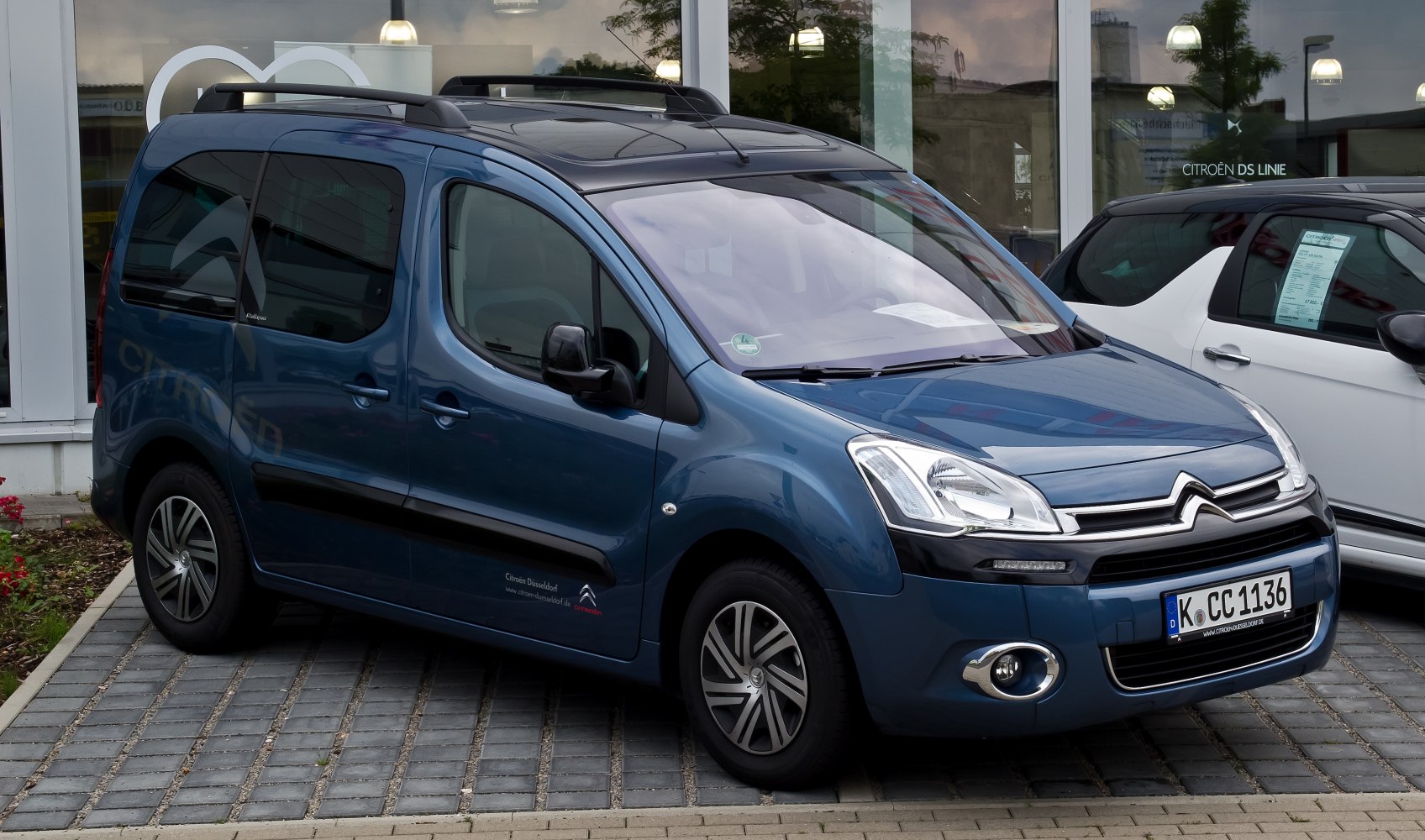 Compact multipurpose van with roof rails and distinctive headlights