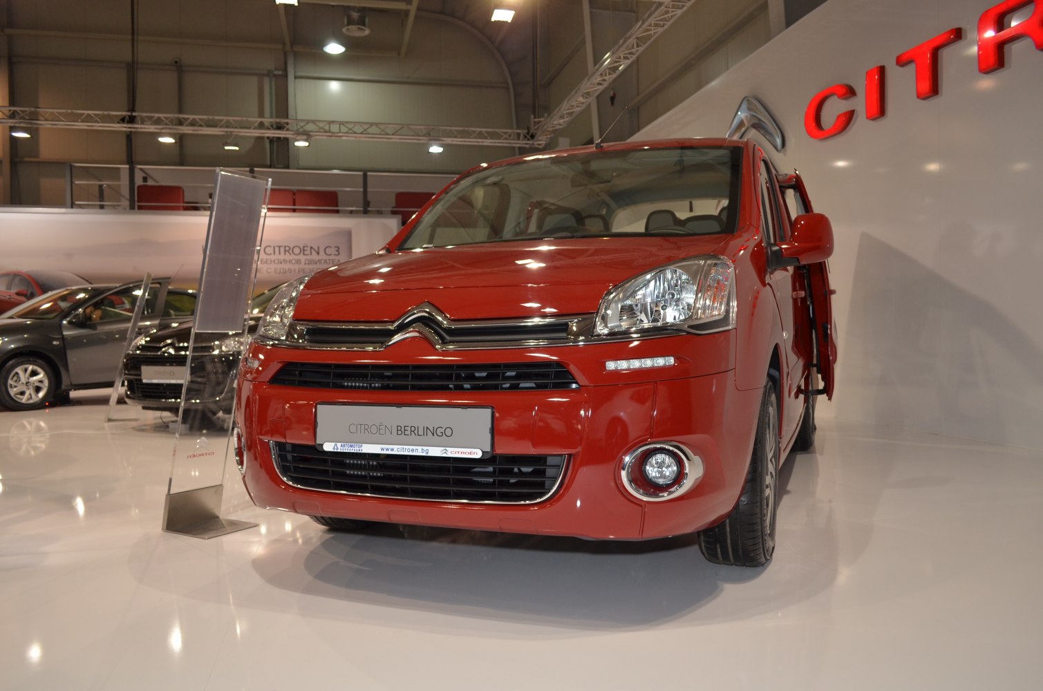 Red vehicle front view with headlight and open side door