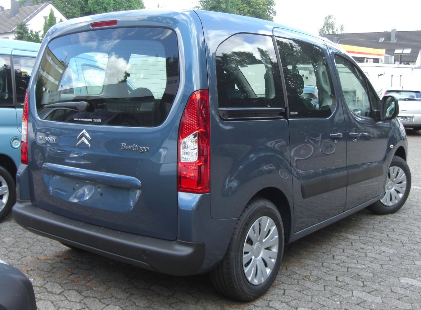Rear view of compact multi-purpose vehicle with large rear window and sliding door