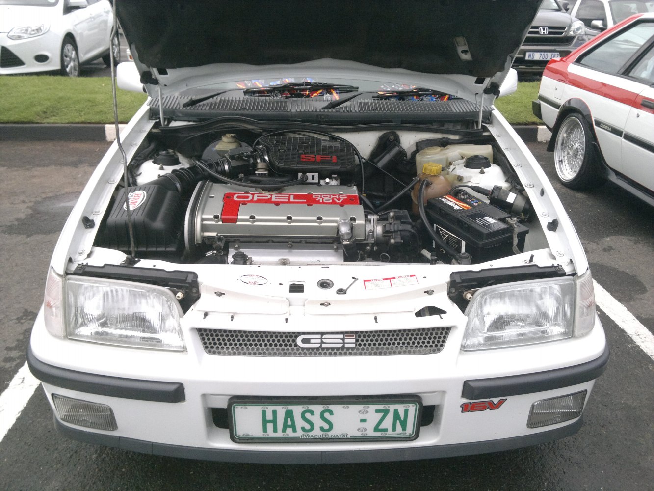 Open engine bay with visible SFI system and 16V engine labeling