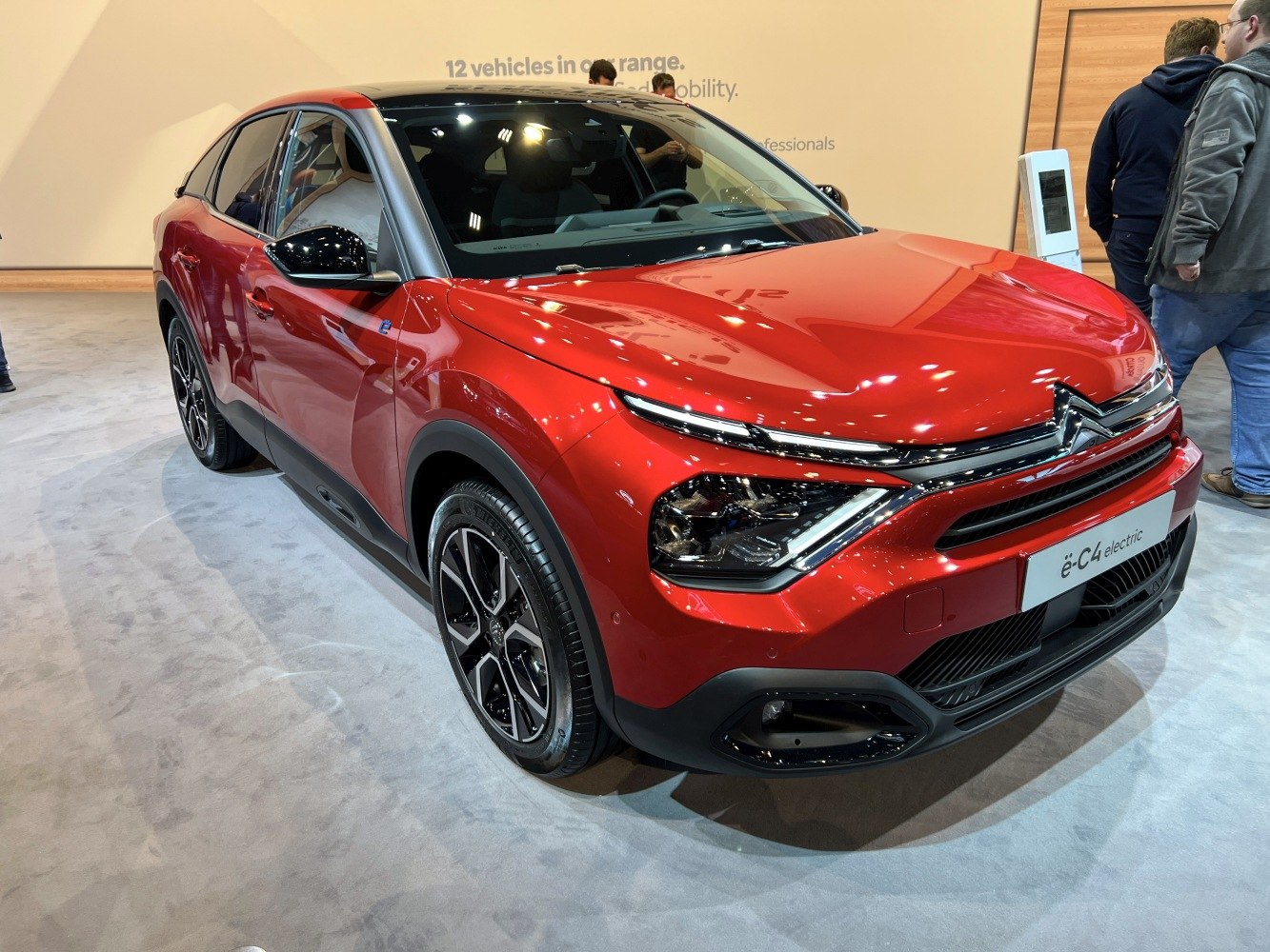 Red electric compact SUV with distinctive dual LED headlights and sleek modern styling