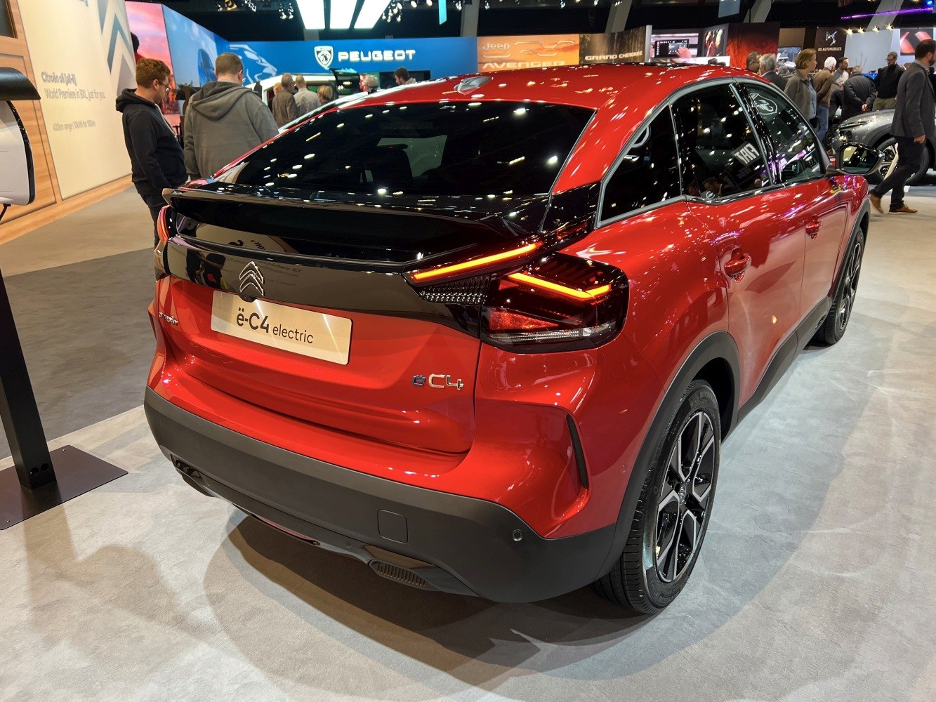 Rear view of red electric hatchback with striking taillights