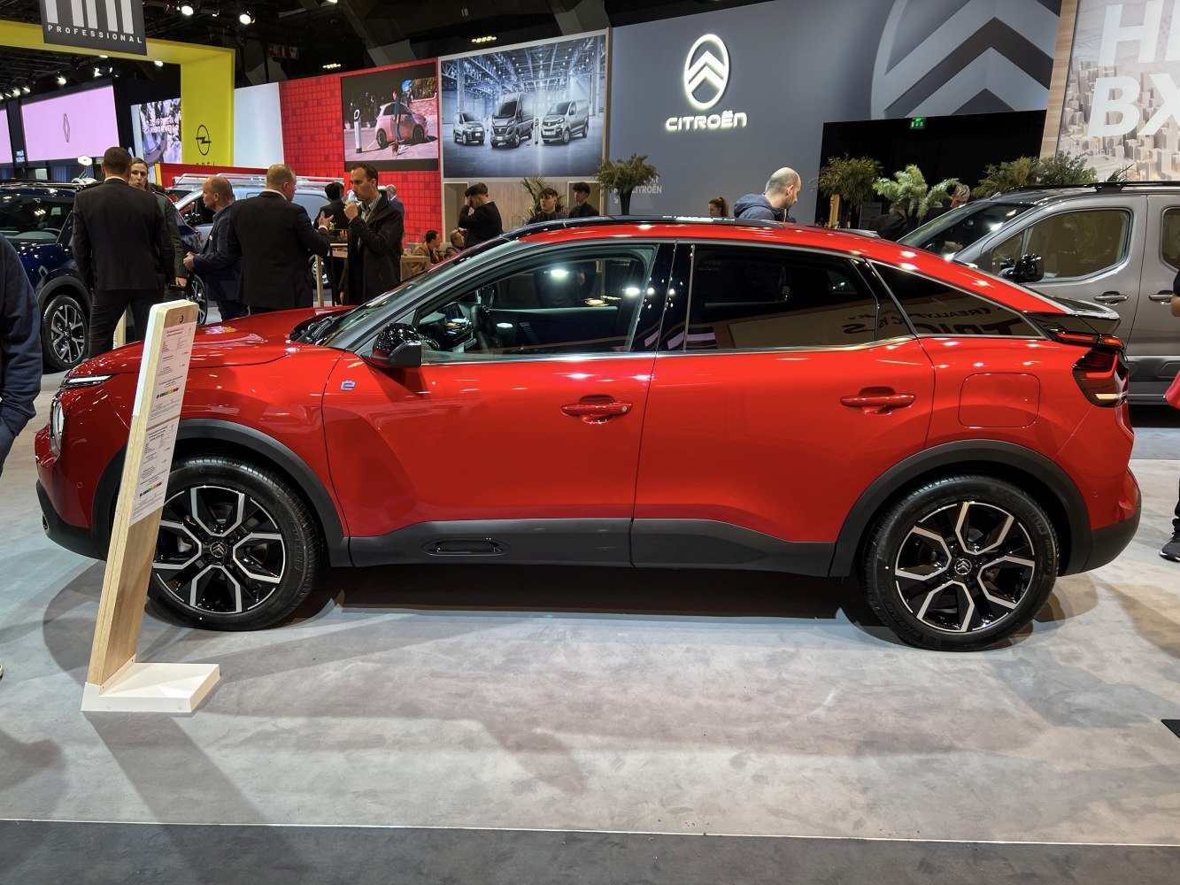 Red modern SUV with black multi-spoke wheels and tinted windows