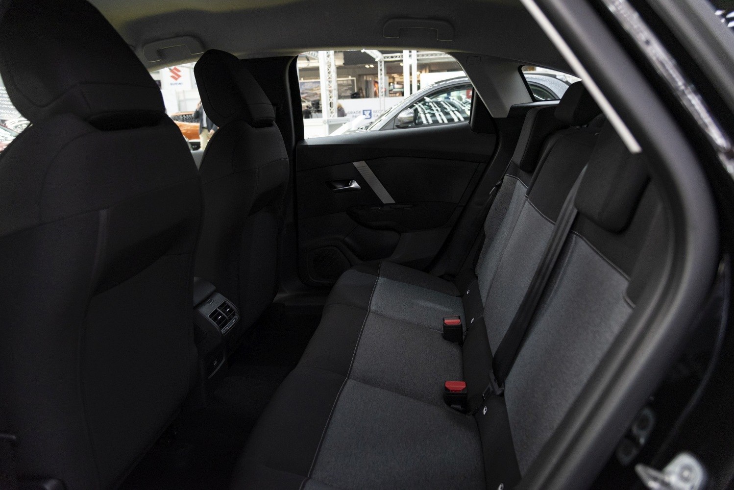 Dual-tone upholstered rear seats with rear air vents in a modern car interior.