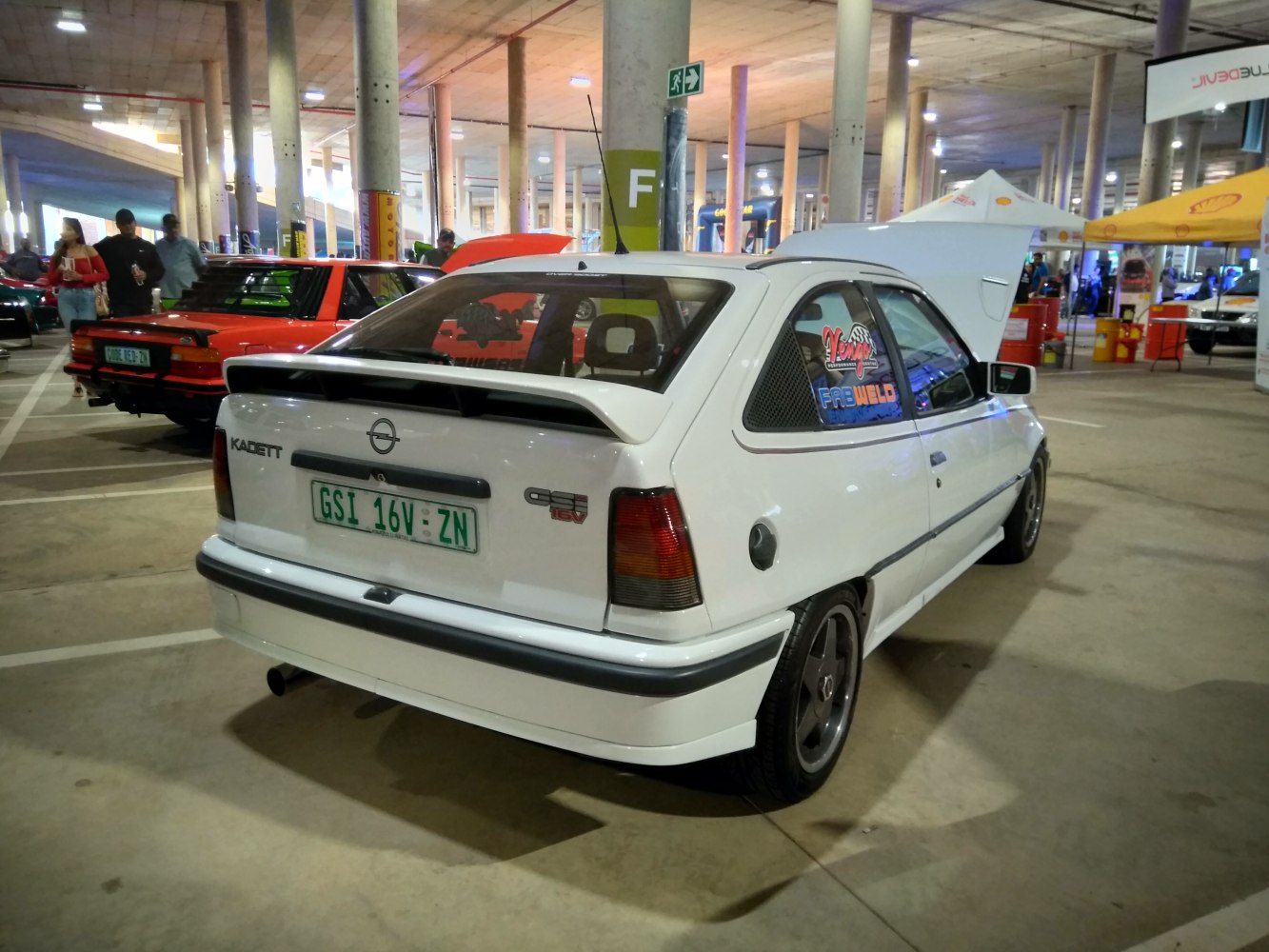 Compact hatchback with rear spoiler and racing decals