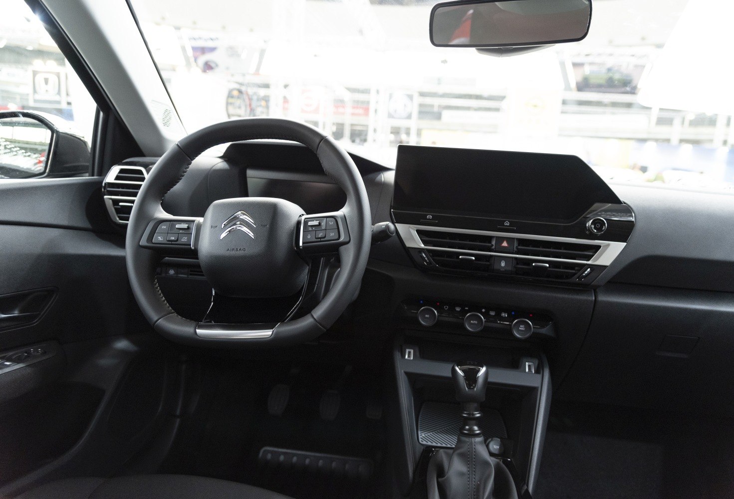 Modern dashboard with touchscreen and multifunction steering wheel.